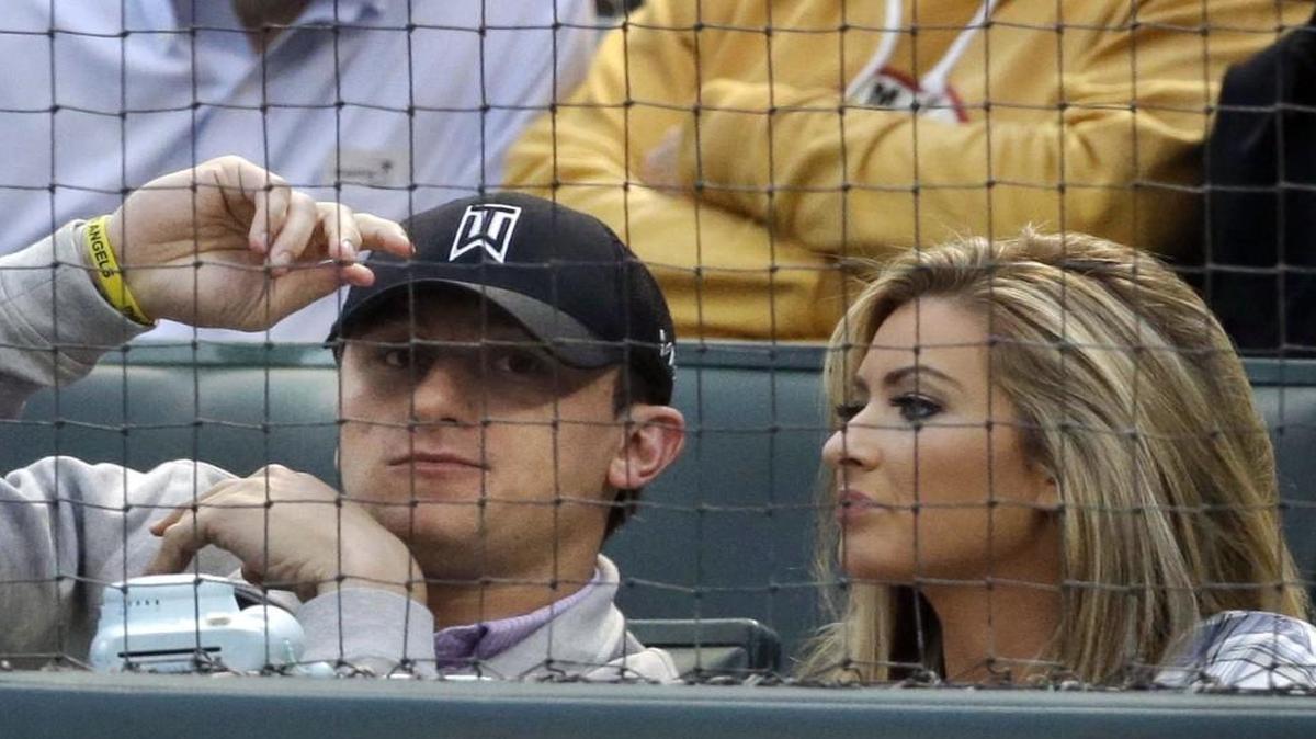 In this April 14, 2015 file photo, former Cleveland Browns quarterback Johnny Manziel sat with Colleen Crowley during a baseball game in Arlington, Texas.