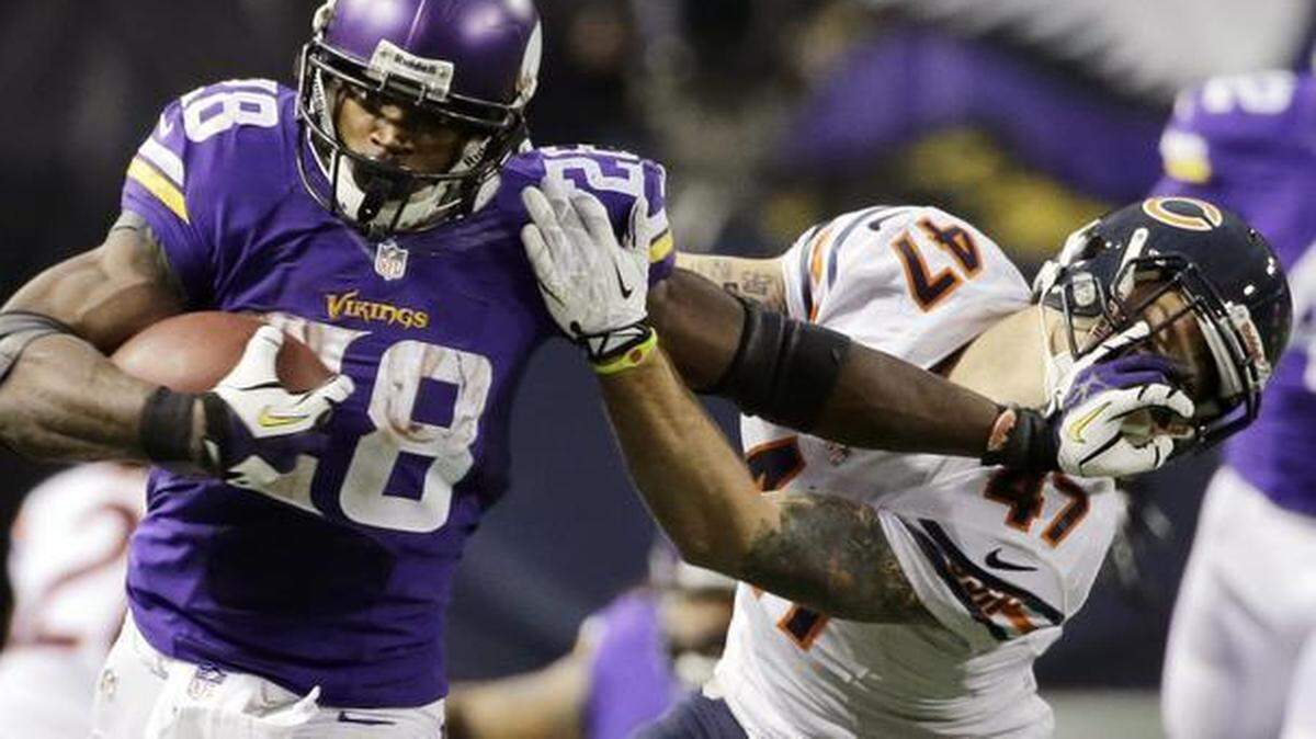 
In this Dec. 1, 2013, file photo, Minnesota Vikings running back Adrian Peterson broke free of a tackle from Chicago Bears free safety Chris Conte. A federal judge has cleared the way for Peterson to be reinstated. U.S. District Judge David Doty issued his order Thursday, Feb. 26, 2015, less than three weeks after hearing oral arguments.
