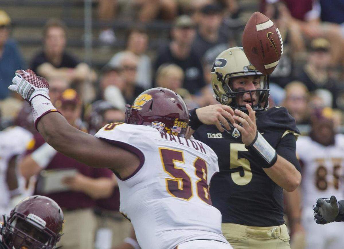 Purdue’s Danny Etling lost the ball after getting hit by Central Michigan’s Leterrius Walton on Saturday, Sept. 6, 2014, at Ross-Ade Stadium in West Lafayette, Ind. Purdue lost 38-17.