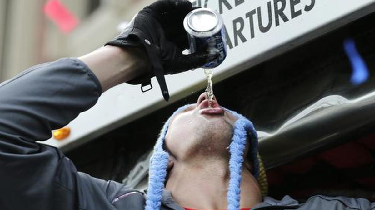 
New England Patriots tight end Rob Gronkowski chugs a Bud Light, tossed to him by a fan, during a parade in Boston Wednesday
