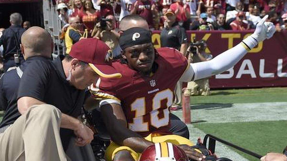 
Washington quarterback Robert Griffin III left the game on a cart after injuring his left ankle during the first half against the Jacksonville Jaguars on Sunday in Landover, Md.
