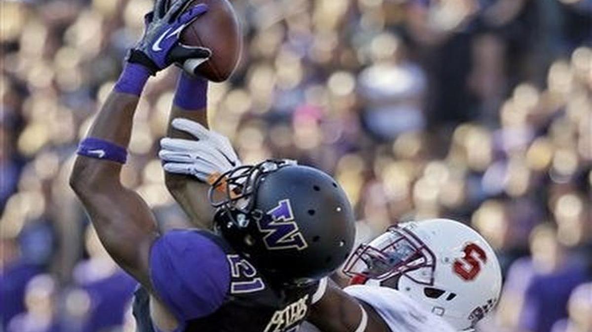 
In this Sept. 27 file photo, Washington's Marcus Peters (left) intercepts a pass in front of Stanford's Ty Montgomery during a college football game in Seattle.
