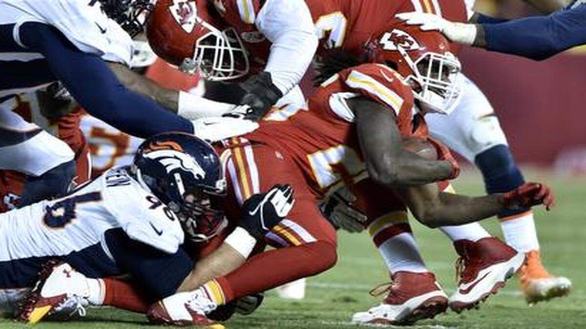 
Kansas City Chiefs running back Jamaal Charles was stopped short of a first down by Denver Broncos defensive tackle Terrance Knighton (98), defensive tackle Mitch Unrein (96) and defensive end DeMarcus Ware (94) in the second quarter on Sunday, Nov. 30, 2014, in Kansas City, Mo.
