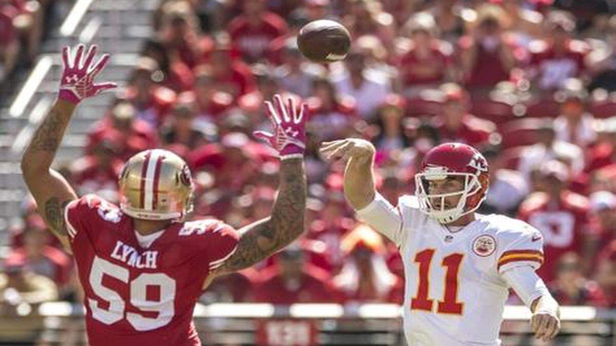 
Chiefs quarterback Alex Smith (left) was pressured by linebacker Aaron Lynch during the loss to the 49ers.
