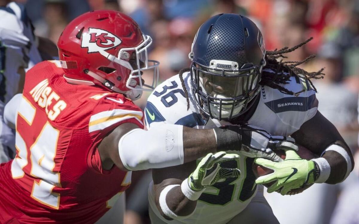 Chiefs linebacker Dezman Moses tried to knock the football out of the arms of Seahawks running back Alex Collins in the second quarter of a preseason game Saturday at Arrowhead Stadium.