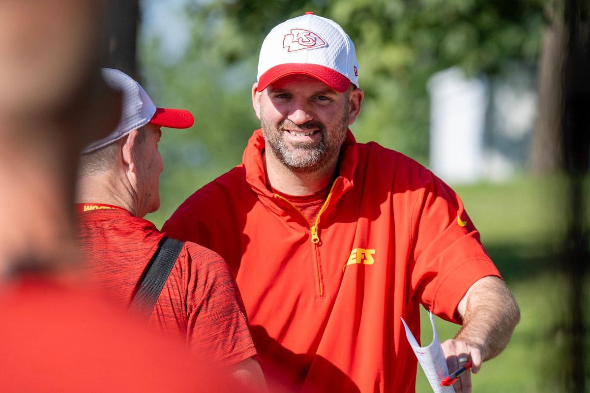 Kansas City Chiefs quarterbacks coach David Girardi embraces Chiefs announcer Mitch Holthus as they walk down to the field for practice at Chiefs training camp on Thursday, July 18, 2024, in St. Joseph.