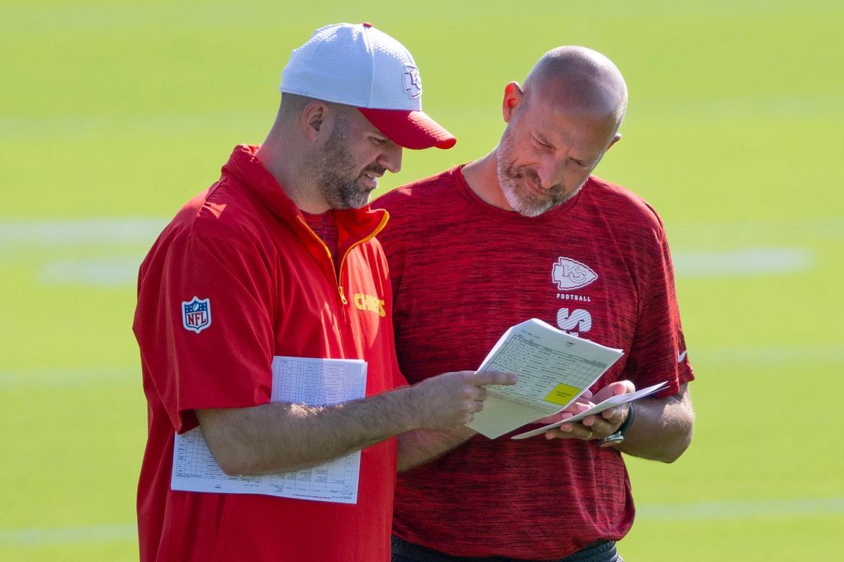 Kansas City Chiefs quarterbacks coach David Girardi, left, and offensive coordinator Matt Nagy look at paperwork together during practice at Chiefs training camp on Wednesday, July 17, 2024, in St. Joseph.