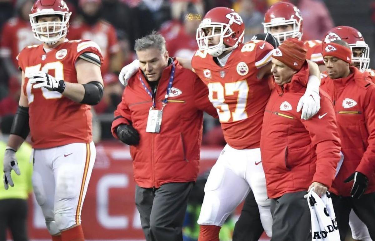 Chiefs tight end Travis Kelce (No. 87) was helped off the field following a hard head-to-head hit by Tennessee’s Johnathan Cyprien during last weekend’s home playoff loss to the Titans.