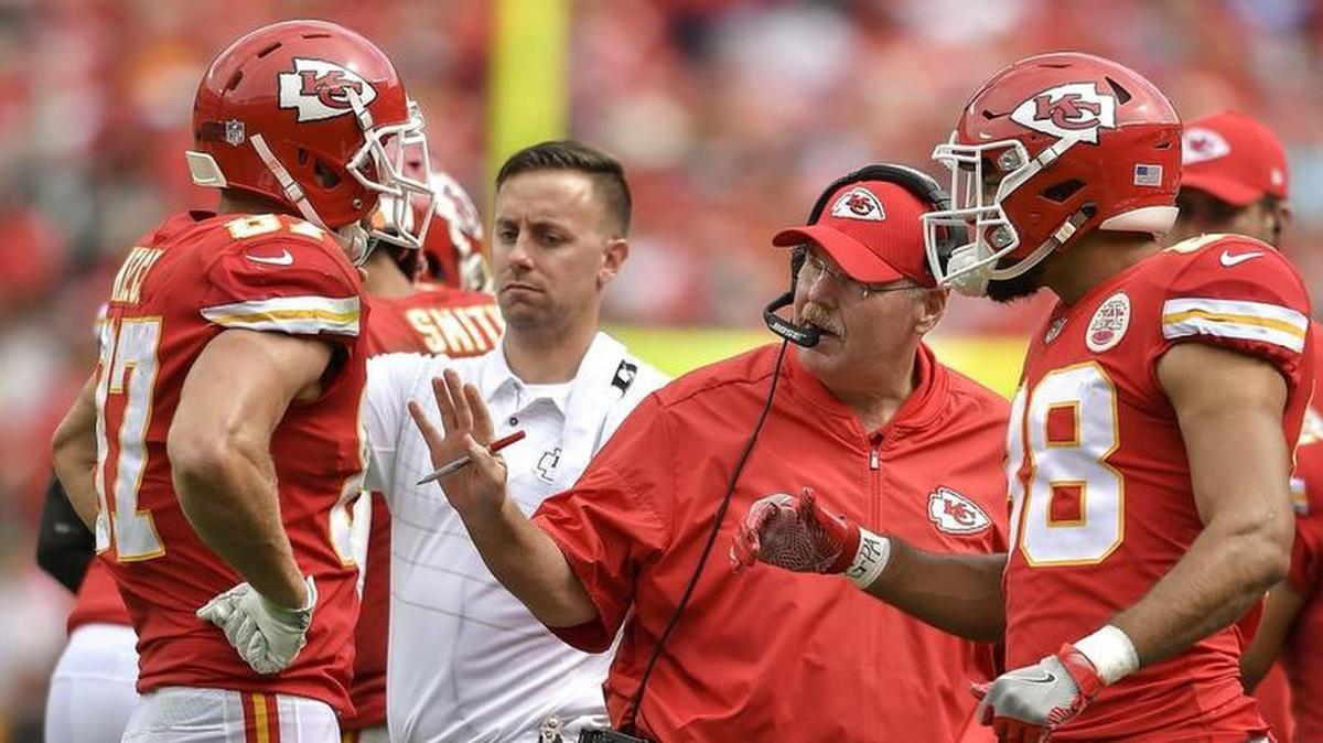 Chiefs coach Andy Reid, center, has helped tight end Travis Kelce, left, learn to keep his emotions in check during games. The result has been exceedingly beneficial to the team.