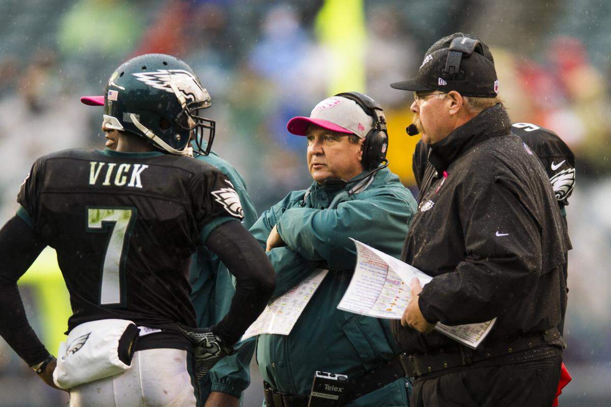 Philadelphia Eagles offensive coordinator Marty Mornhinweg and head coach Andy Reid talks with quarterback Michael Vick (7) during the fourth quarter against the Atlanta Falcons on Oct. 28, 2012, at Lincoln Financial Field in Philadelphia. The Falcons defeated the Eagles 30-17.