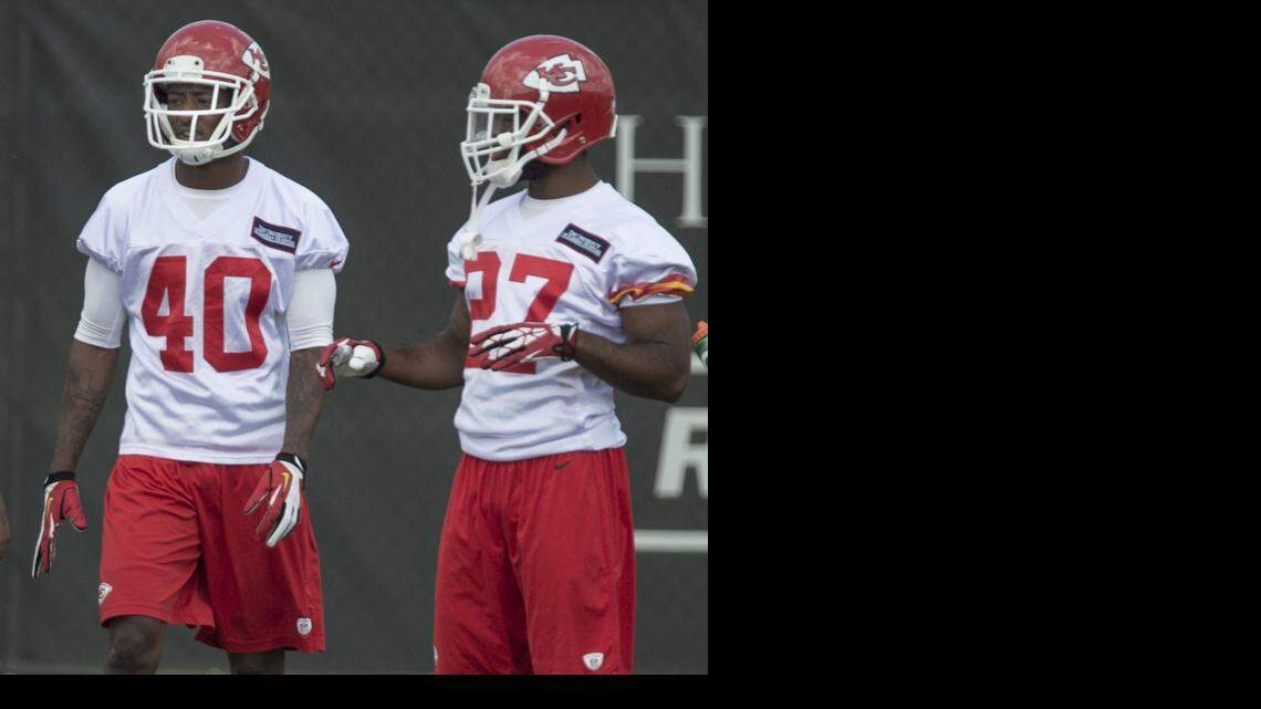 
DeMarcus Van Dyke (left) listened as David Van Dyke talked during warm-ups for OTA's at the Chief's practice facility on Wednesday, May 29, 2014 in Kansas City, Missouri. The Van Dyke's, who are cousins, have waited their whole lives to play on the same team together, but the two cornerbacks are fighting for the same job with the Chiefs.
