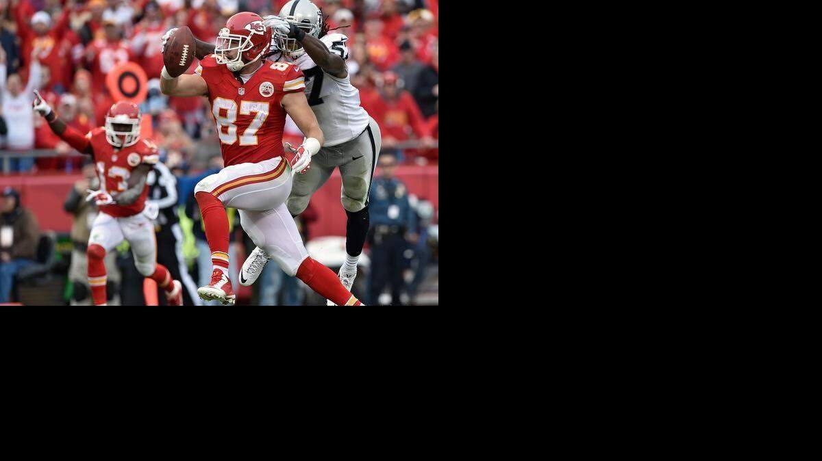 
Kansas City Chiefs tight end Travis Kelce scored a touchdown in front of Oakland Raiders linebacker Ray-Ray Armstrong (57) in the third quarter on Dec. 14, 2014, at Arrowhead Stadium.
