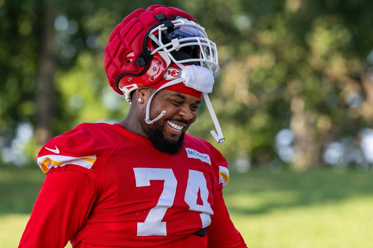 Kansas City Chiefs offensive tackle Jawaan Taylor (74) smiles as he walks down to the field for practice at Chiefs training camp on Monday, July 29, 2024, in St. Joseph.