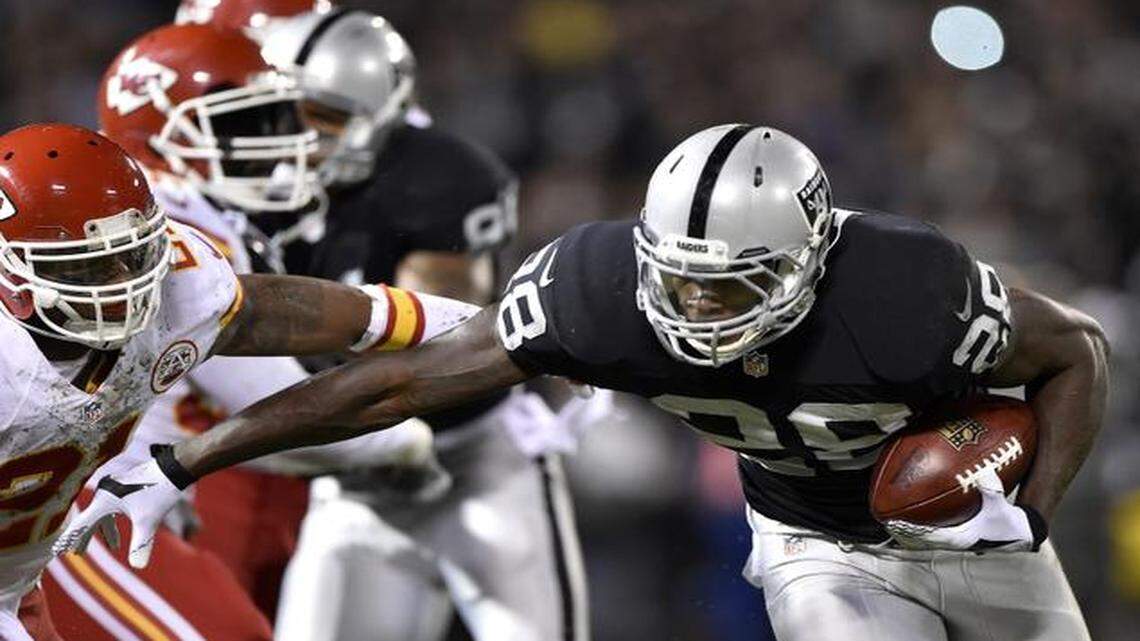 
Kansas City Chiefs cornerback Sean Smith (left) tried to bring down Oakland Raiders running back Latavius Murray during last month’s game.


