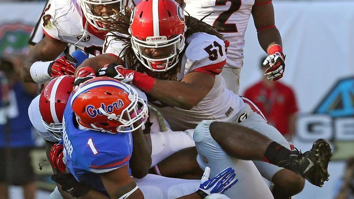 
Florida receiver Quinton Dunbar (1) was stopped short of a first down by Georgia linebacker Ramik Wilson (51) and teammates in a 2014 game.
