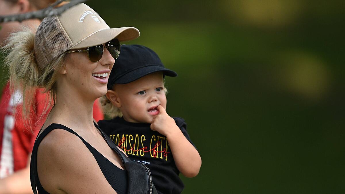 Brittany Mahomes carries 1-year-old son Bronze from the golf cart as she arrives to watch training camp at Missouri Western State University on Saturday, July 27, 2024, in St. Joseph.