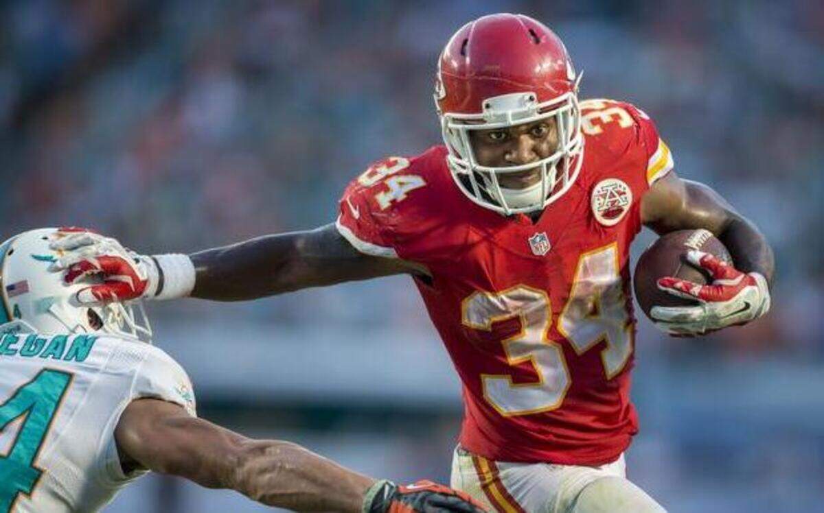 
Chiefs running back Knile Davis drops a Marshawn Lynch-esque stiff-arm onto Dolphins corner Cortland Finnegan during Sunday’s win at Miami. 
