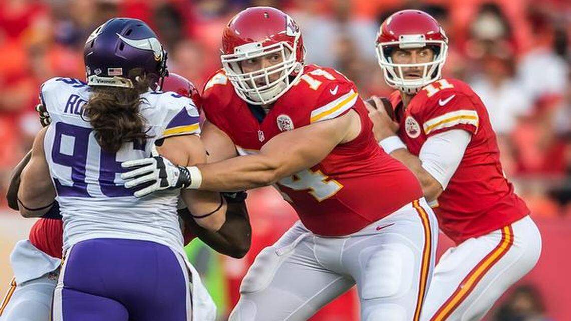 The Chiefs’ Jeff Linkenbach (center), who made a block on the Vikings’ Brian Robison, started at left guard Saturday night.