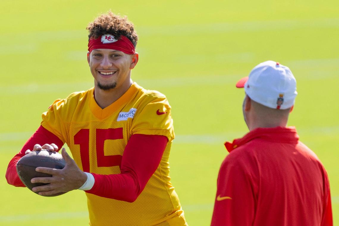 Kansas City Chiefs quarterback Patrick Mahomes (15) smiles as he catches a football during practice at Chiefs training camp on Wednesday, July 17, 2024, in St. Joseph.