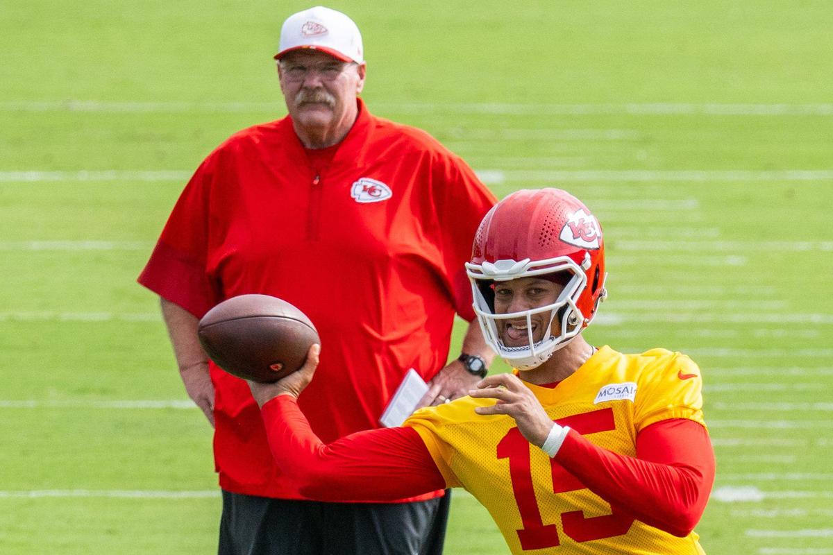 Kansas City Chiefs quarterback Patrick Mahomes (15) winds up for a throw while head coach Andy Reid watches on the first day of Chiefs training camp on Tuesday, July 22, 2025 in St. Joseph.