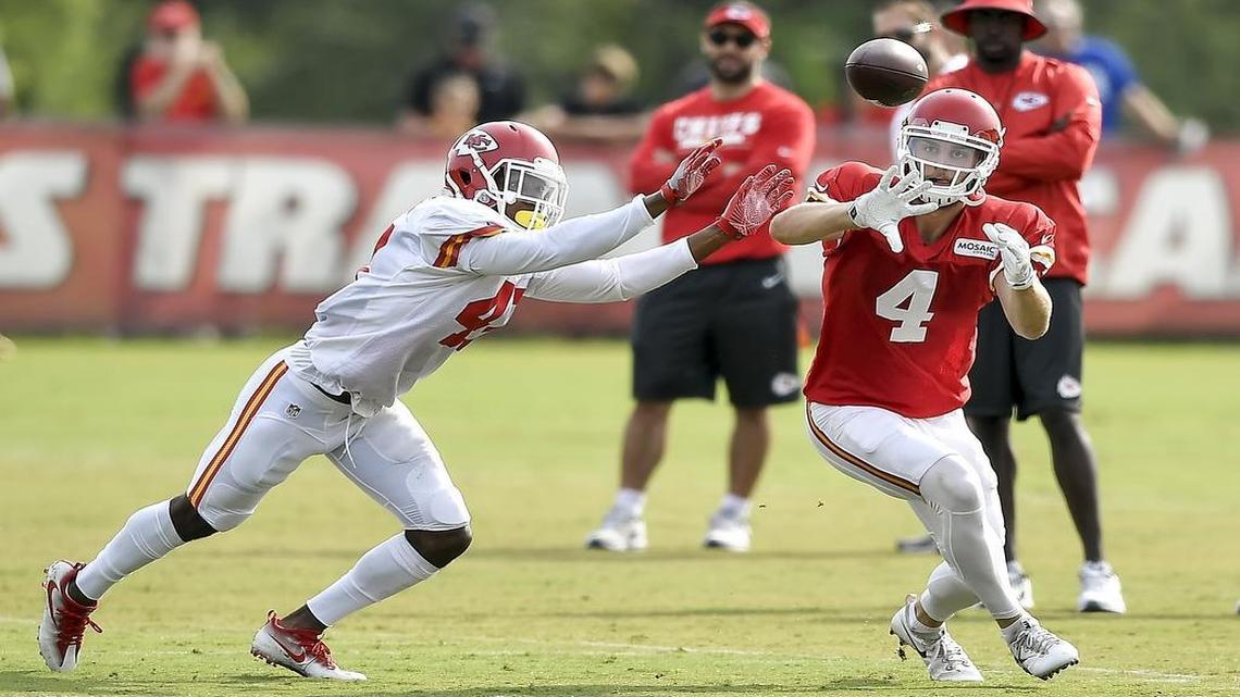Kansas City Chiefs wide receiver Gehrig Dieter (4) reached for a pass thrown by Patrick Mahomes with defense from Trevon Hartfield during Monday's team training camp practice in St. Joseph, Mo.