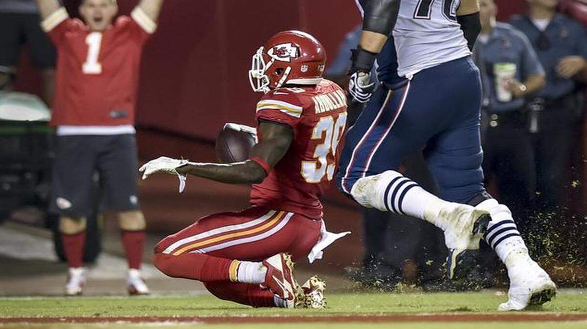 
Chiefs free safety Husain Abdullah (39) slid in the end zone after returning an interception for a touchdown in the Chiefs’ 41-14 victory over New England on Monday night. Abdullah then bowed his head in prayer after the slide and was penalized for excessive celebration.
