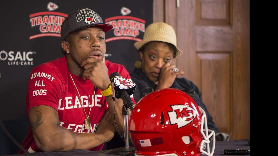 Kansas City Chiefs safety Eric Berry, left, spoke about his cancer treatment for his Hodgkin's lymphoma while his mother, Carol Berry, right, wept during a press conference at Missouri Western State University in St. Joseph, Mo. Berry returned to practice with the team on Wednesday.