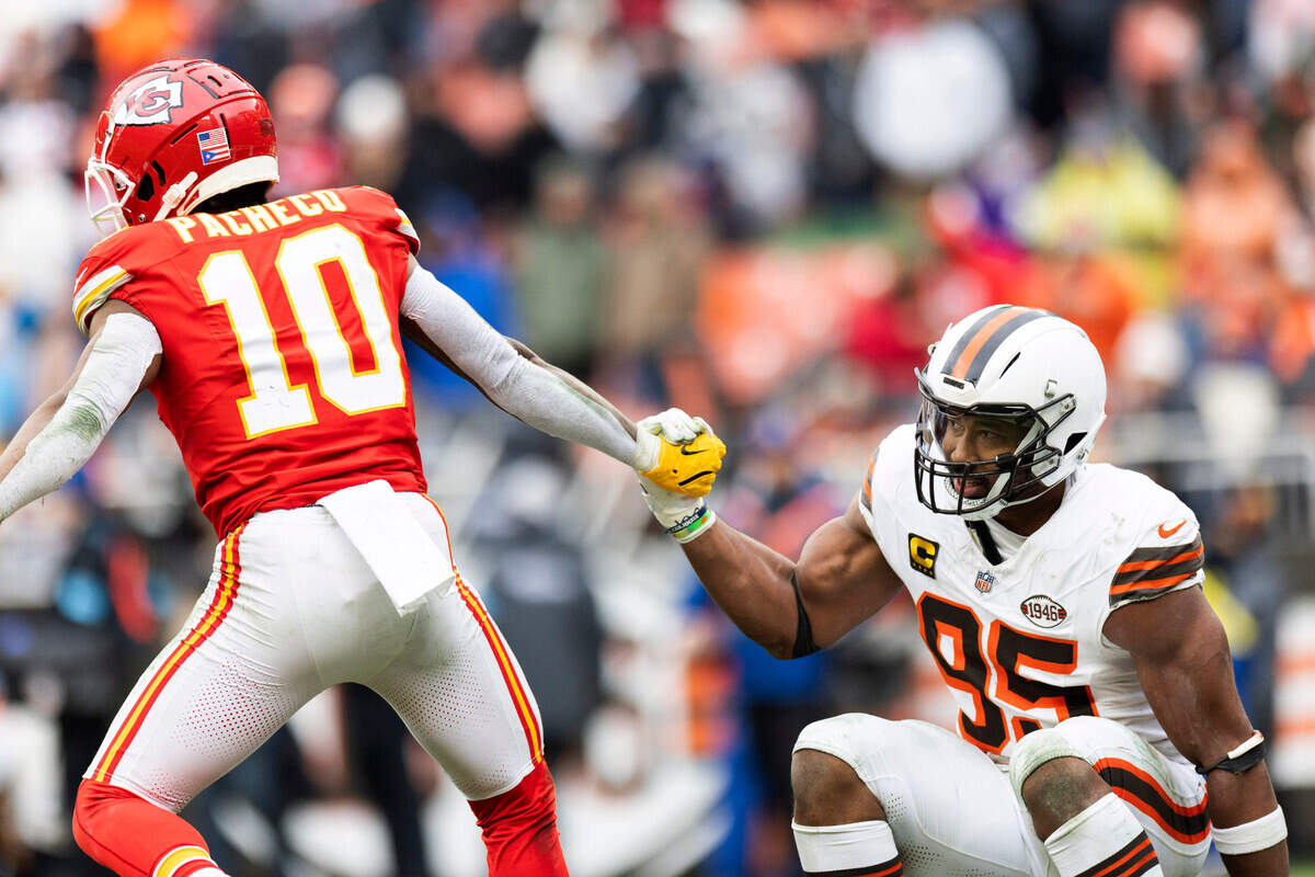 Cleveland Browns defensive end Myles Garrett (95) is helped up by Kansas City Chiefs running back Isiah Pacheco (10) during the third quarter on Dec. 15, 2024, at Huntington Bank Field in Cleveland.