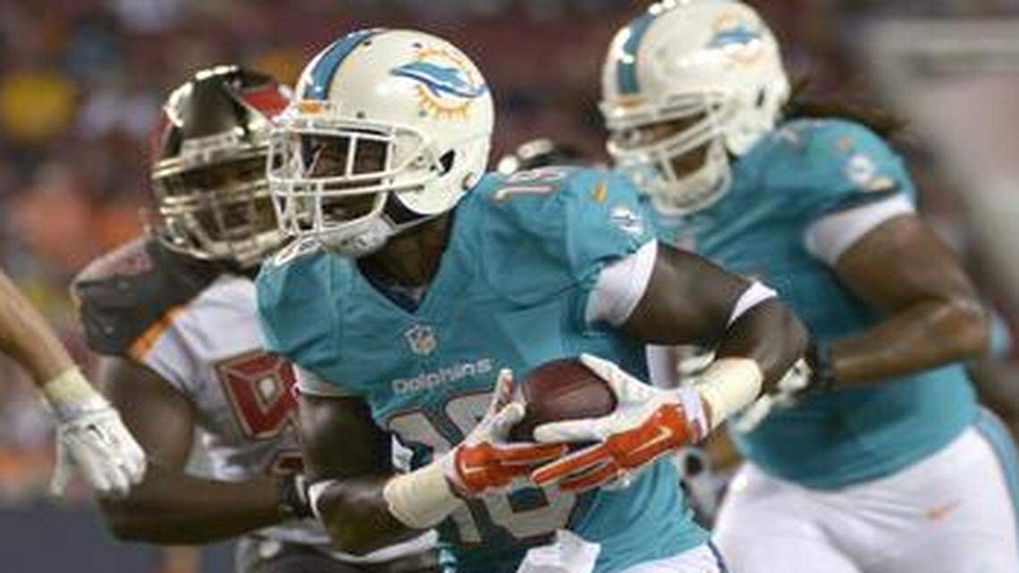 
Miami Dolphins wide receiver Armon Binns ran past Tampa Bay Buccaneers middle linebacker Dane Fletcher in a preseason game in Tampa, Fla., on Aug. 16, 2014.
