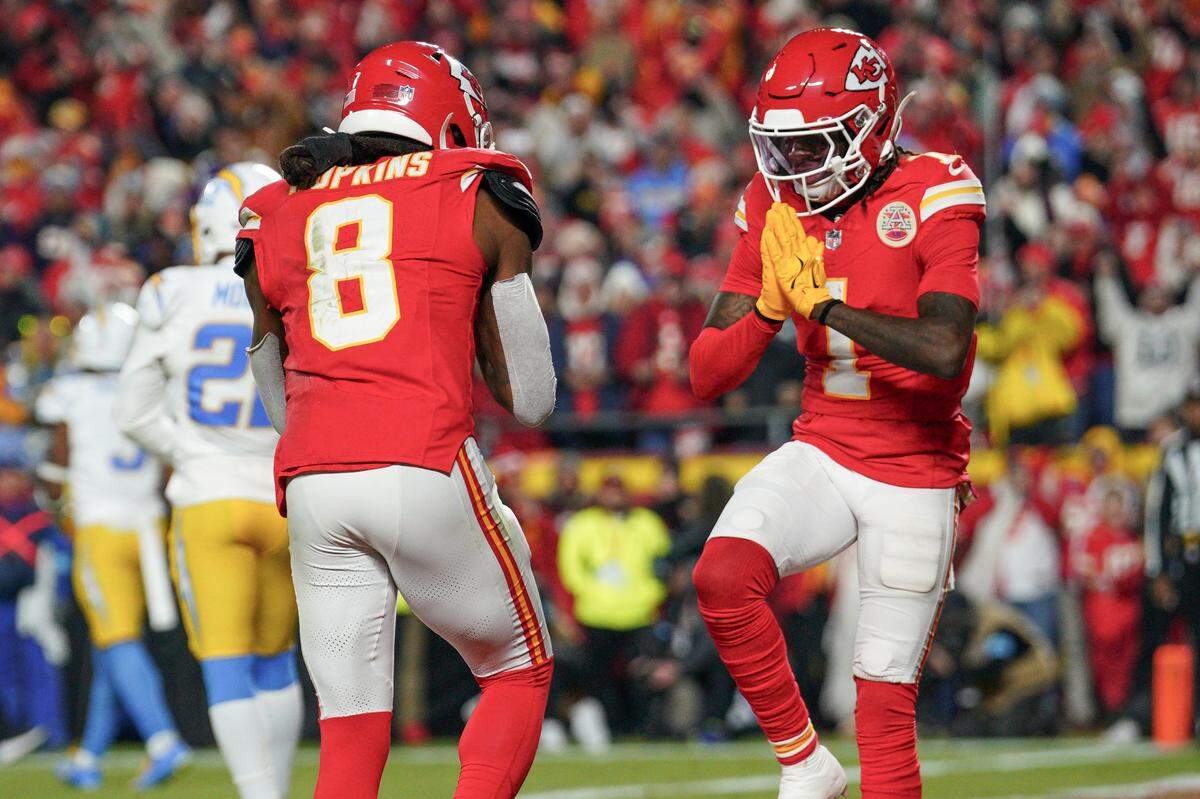 Kansas City Chiefs wide receiver DeAndre Hopkins (8) celebrates with wide receiver Xavier Worthy (1) after scoring against the Los Angeles Chargers during the first half on Dec. 8, 2024, at GEHA Field at Arrowhead Stadium in Kansas City.