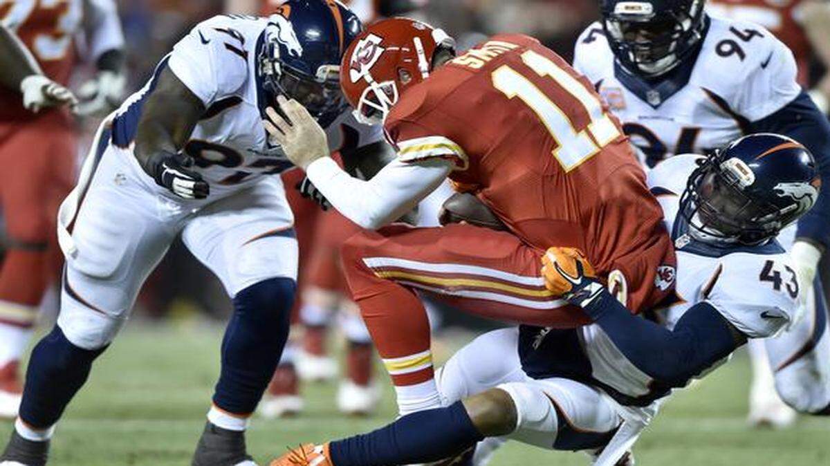 
Denver Broncos defensive end Malik Jackson (97) arrived to help strong safety T.J. Ward (43) sack Chiefs quarterback Alex Smith (11) in the first quarter Sunday night at Arrowhead Stadium. The Broncos beat the Chiefs 29-16 to retain sole possession of first place in the AFC West.
