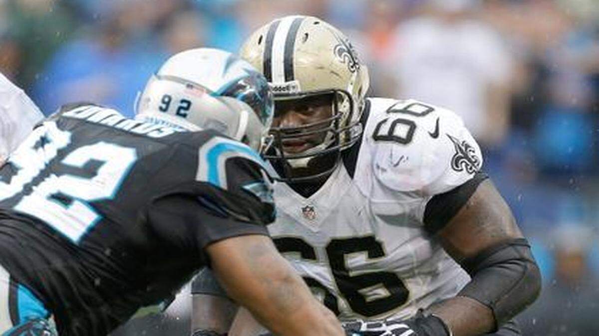 
Ben Grubbs prepared to block Carolina’s Dwan Edwards (left) during a 2013 game.
