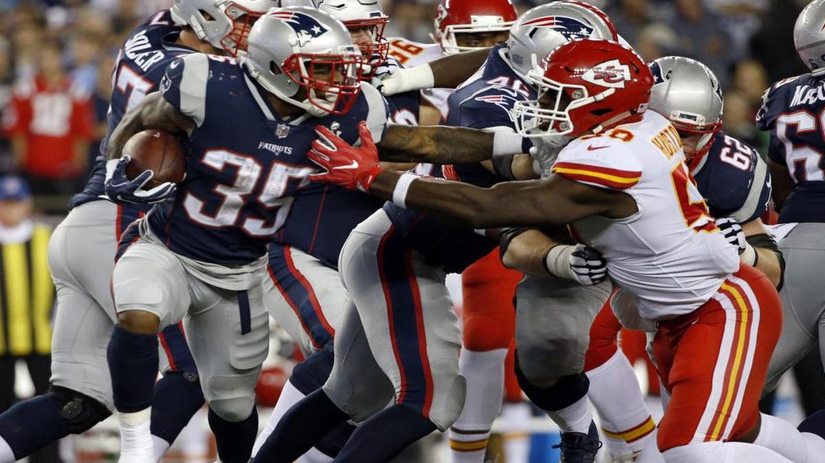 Patriots running back Mike Gillislee tried to get away from Chiefs linebacker Justin Houston (50) in the second half of Thursday’s game in Foxborough, Mass.