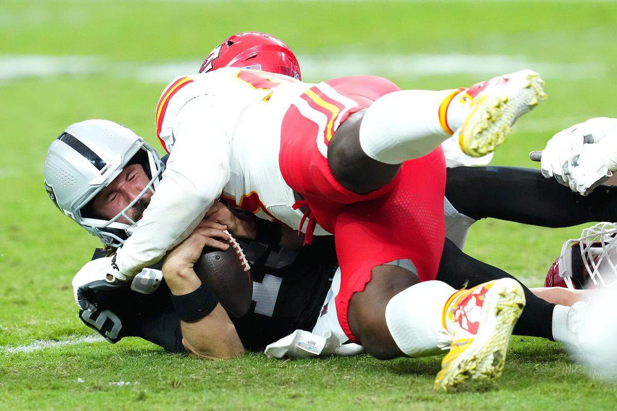 Vegas Raiders quarterback Gardner Minshew (15) is sacked by Kansas City Chiefs defensive tackle Tershawn Wharton (98) during the third quarter at Allegiant Stadium on Oct. 27, 2024 in Las Vegas.