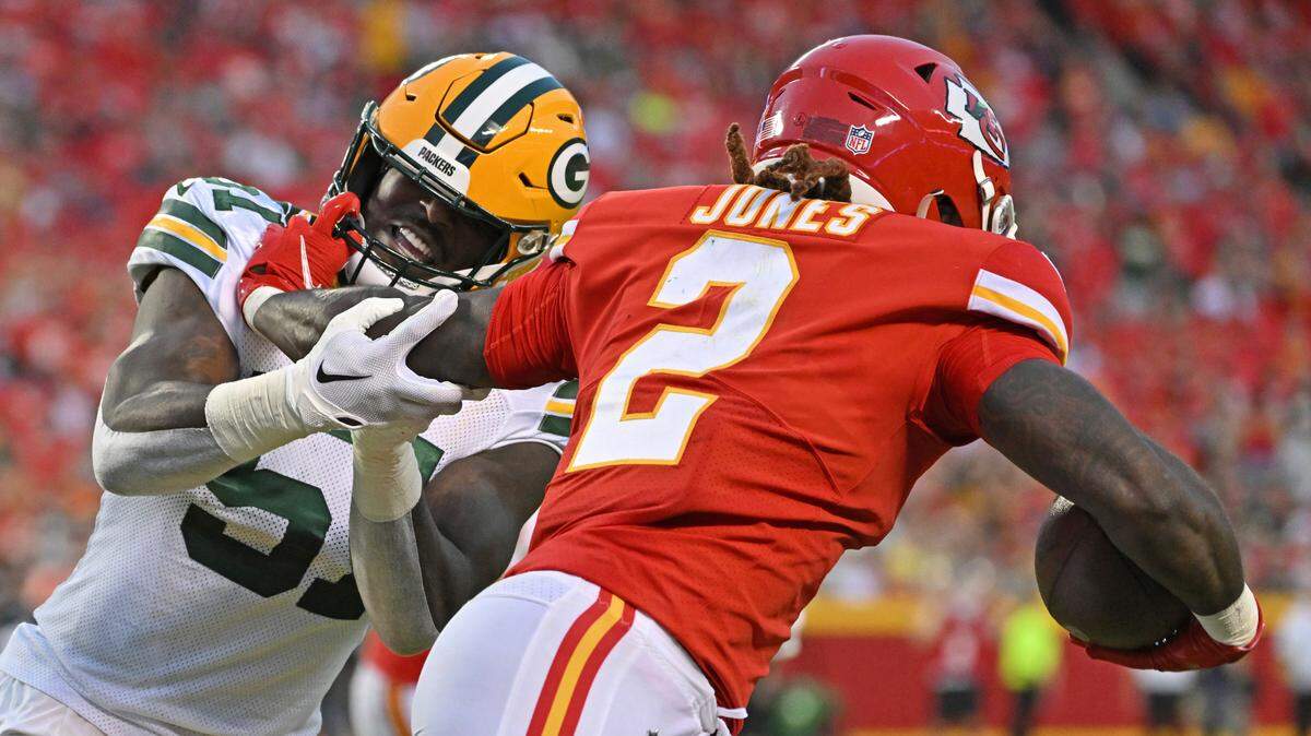 Green Bay Packers linebacker Krys Barnes (51) attempts to tackle Kansas City Chiefs running back Ronald Jones (2) during an NFL pre-season football game Thursday, Aug. 25, 2022, in Kansas City, Mo.