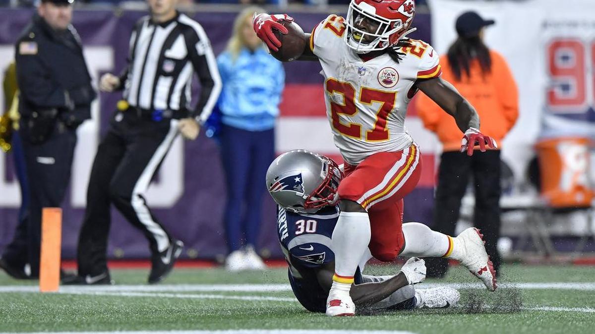 Kansas City Chiefs running back Kareem Hunt is tackled by New England Patriots cornerback Jason McCourty as Hunt enters the end zone in the third quarter to score off a long pass by Chiefs quarterback Patrick Mahomes during Sunday’s football game on October 14, 2018, at Gillette Stadium in Foxborough, Mass.