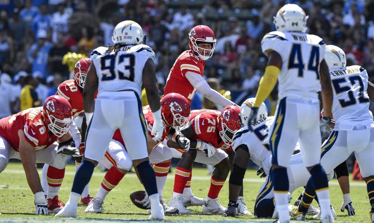 Kansas City Chiefs quarterback Patrick Mahomes steps to the left of center to allow running back Spencer Ware to take the snap and rush with the ball in the second quarter during Sunday’s football game against the Los Angeles Chargers on September 9, 2018 at the StubHub Center in Carson, Calif.