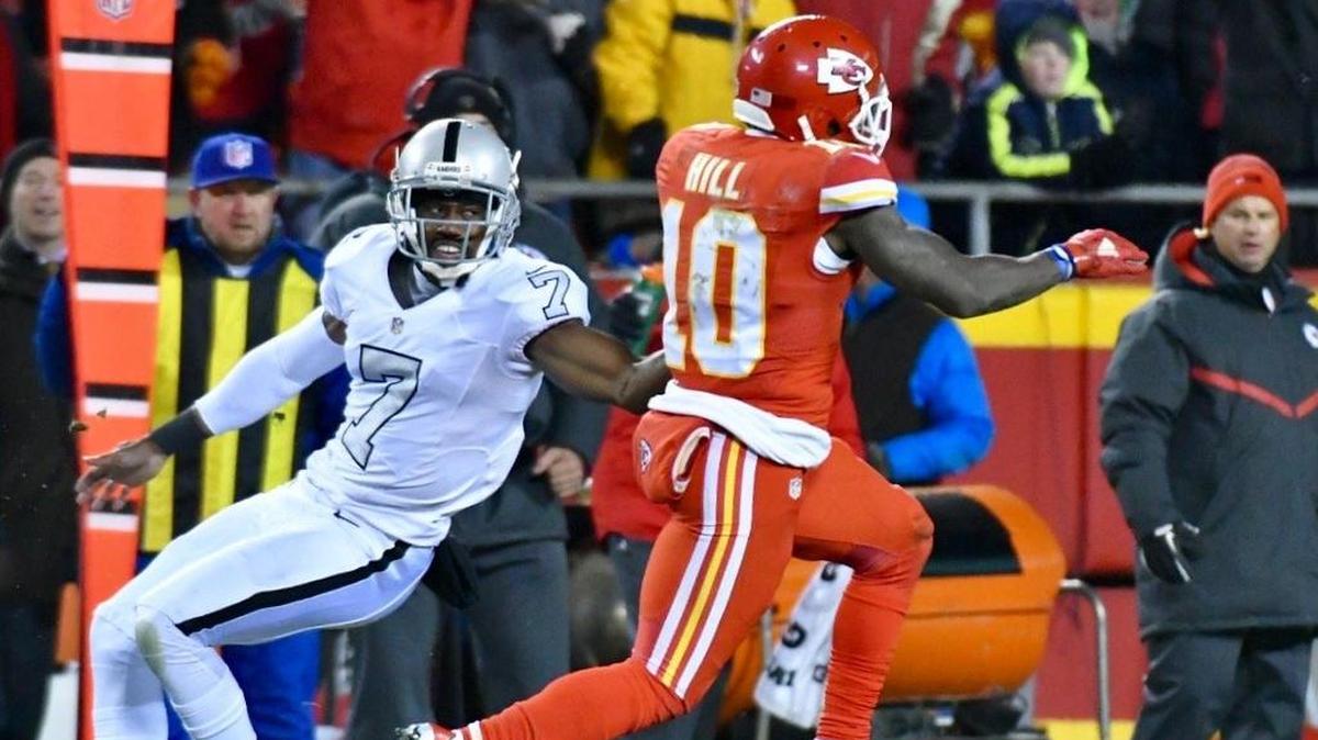 Kansas City Chiefs Tyreek Hill returns a punt for a touchdown past Oakland Raiders Marquette King during Thursday’s football game at Arrowhead Stadium.