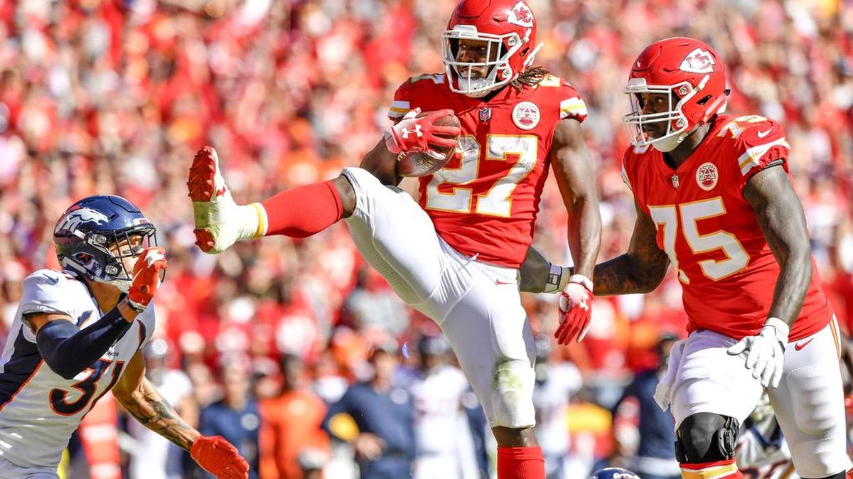 With blocking by Kansas City Chiefs offensive guard Cameron Erving, running back Kareem Hunt made a giant leap over the Denver defense and then battled Denver Broncos free safety Justin Simmons on a 23-yard touchdown run in the third quarter during Sunday’s football game on October 28, 2018 at Arrowhead Stadium in Kansas City, Mo.