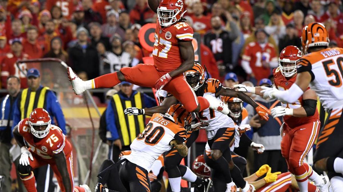 After breaking away from a Cincinnati tackler, Kansas City’s Kareem Hunt (27) leaps over the Bengals’ Jessie Bates and heads down field to help set up a Chiefs touchdown, when quarterback Patrick Mahomes completed a short pass to Hunt during the first quarter of Sunday night’s game at Arrowhead Stadium in Kansas City, Mo.