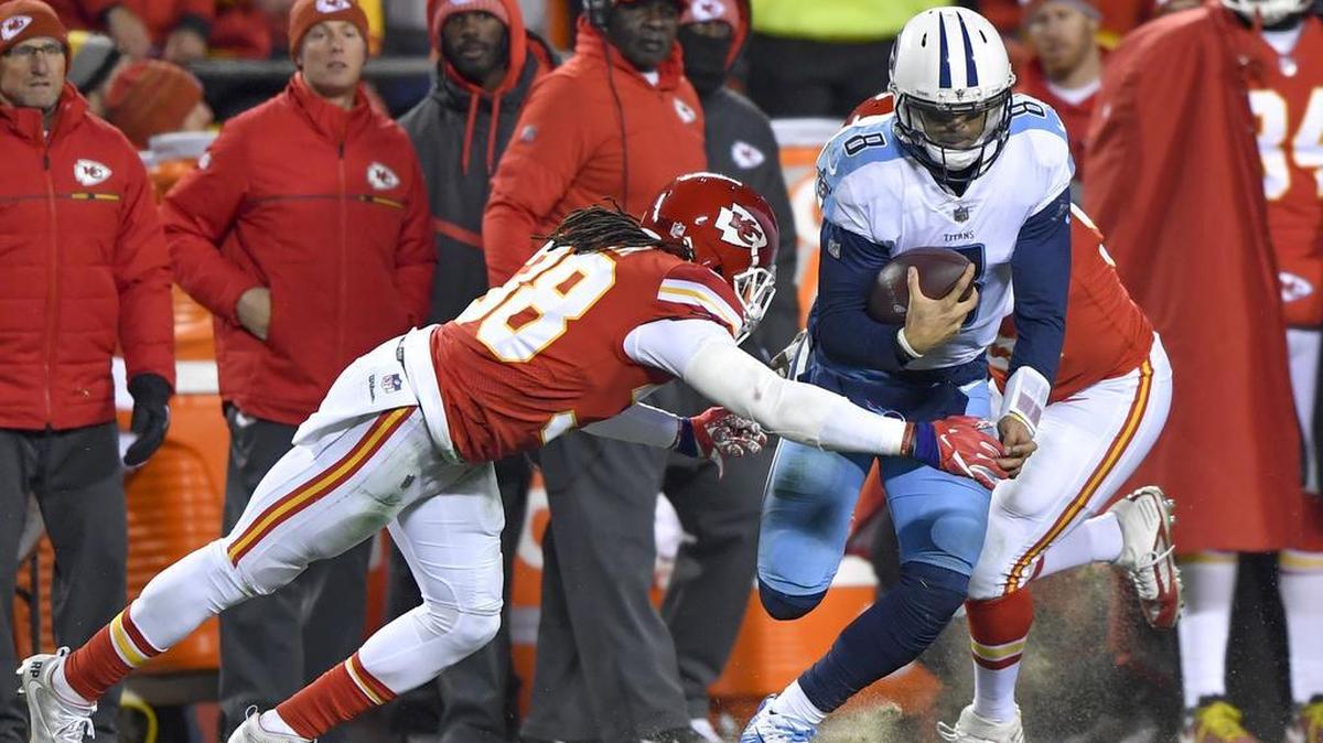 Kansas City Chiefs free safety Ron Parker (38) tackled Tennessee Titans' Marcus Mariota (8) along the Chiefs sideline in the fourth quarter during the Kansas City Chiefs and Tennessee Titans football game at Arrowhead Stadium on Saturday, January 6, 2018, in Kansas City, Missouri.