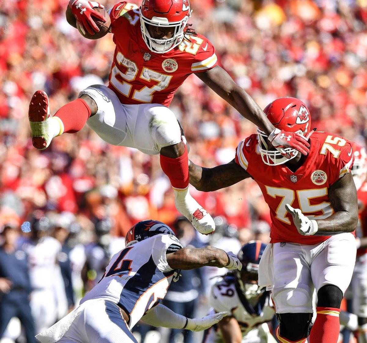 Chiefs running back Kareem Hunt leaps over Denver Broncos defensive back Will Parks last weekend at Arrowhead Stadium.