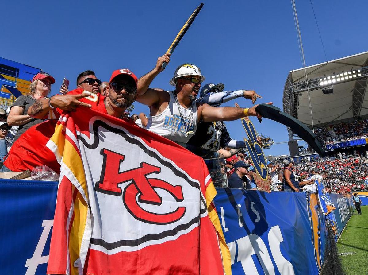 A Kansas City Chiefs fan slips in his team flag as Los Angeles Chargers fans try to cheer on the team during Sunday’s football game on September 9, 2018 at the StubHub Center in Carson, Calif.
