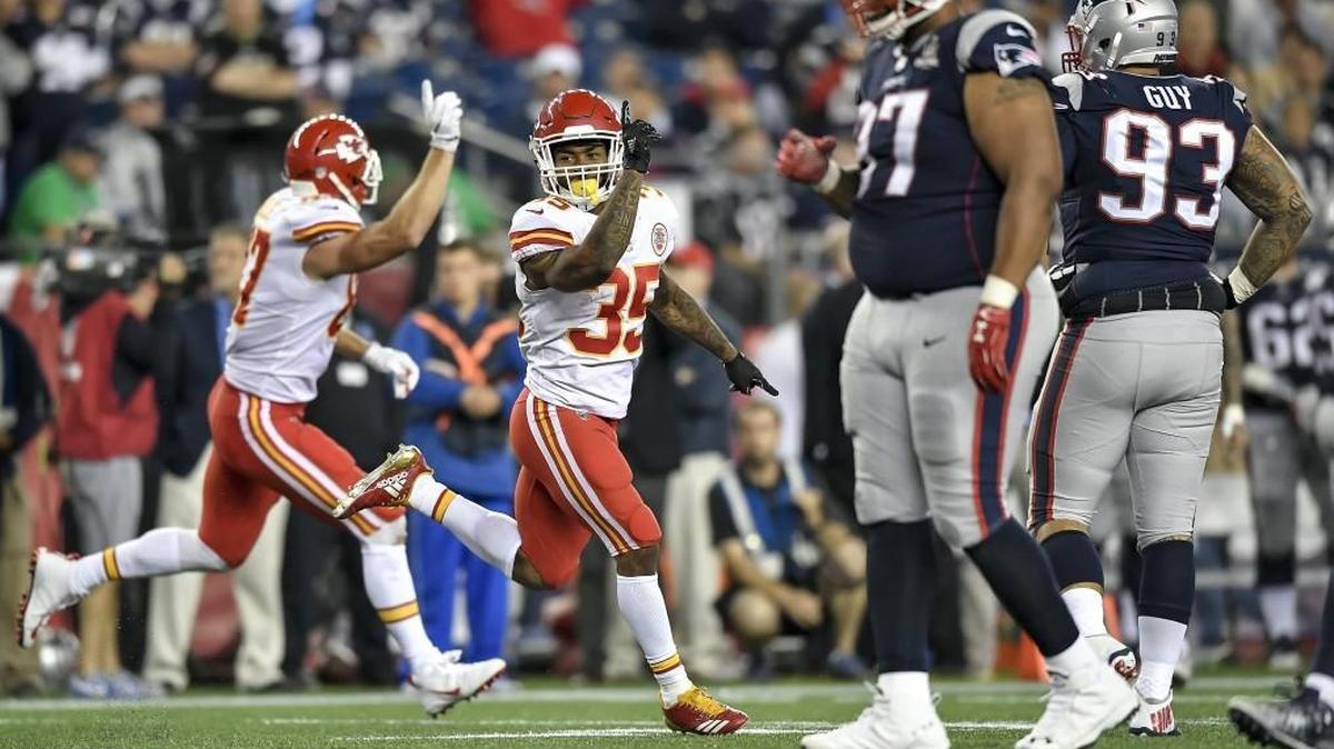 Running back Charcandrick West (35) and teammate Travis Kelce celebrate the Chiefs’ final touchdown in their 42-27 win over the New England Patriots during the season opener.