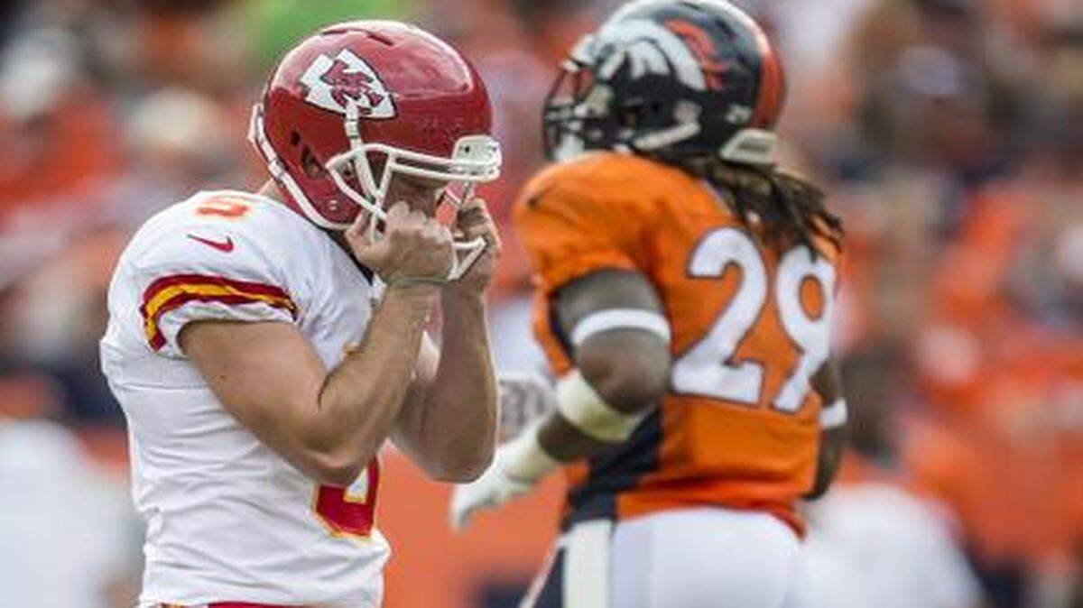 
Kansas City Chiefs kicker Cairo Santos (5) grabbed his face mask after missing wide right on a 37-yard field goal in the third quarter of a 24-17 loss at Denver on Sunday.
