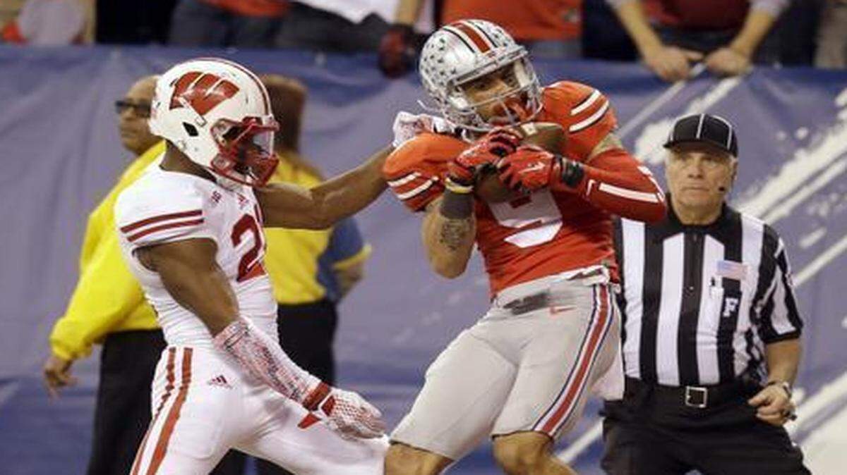 
Ohio State wide receiver Devin Smith (right) caught a 42-yard pass for a touchdown against Wisconsin cornerback Peniel Jean in the Big Ten Conference Championship Game.
