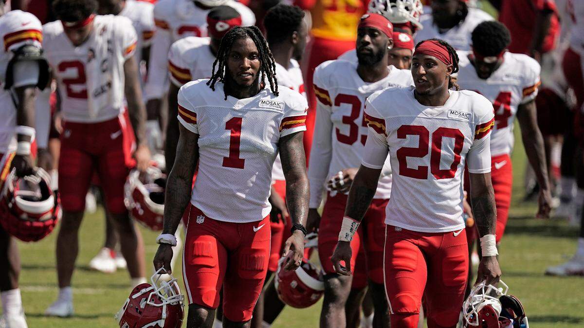 Kansas City Chiefs cornerback Lonnie Johnson (1) and safety Justin Reid (20) walk between drills during NFL football training camp Monday, Aug. 1, 2022, in St. Joseph, Mo.