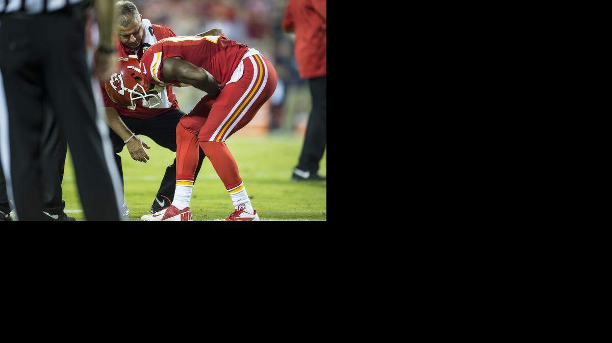 
Kansas City Chiefs wide receiver Donnie Avery (17) was bent over during an injury with trainer Rick Burkholder against the New England Patriots at Arrowhead Stadium on Monday night. Avery underwent surgery for a sports hernia.
