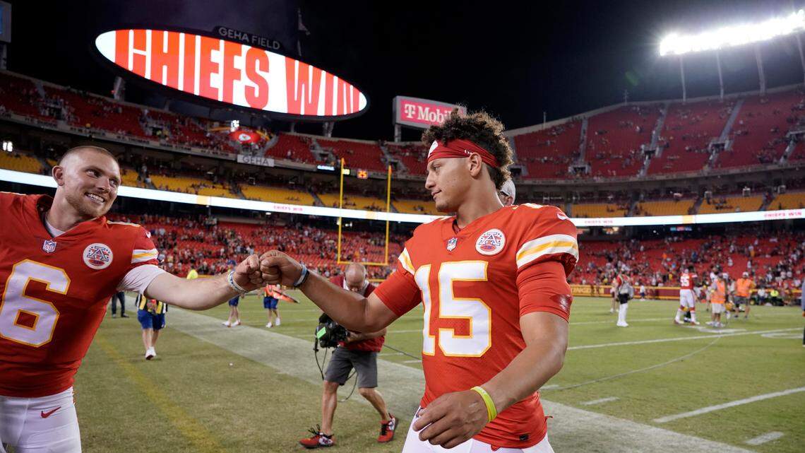 Kansas City Chiefs quarterbacks Patrick Mahomes (15) and Shane Buechele (6) celebrate following an NFL preseason football game against the Green Bay Packers Thursday, Aug. 25, 2022, in Kansas City, Mo.