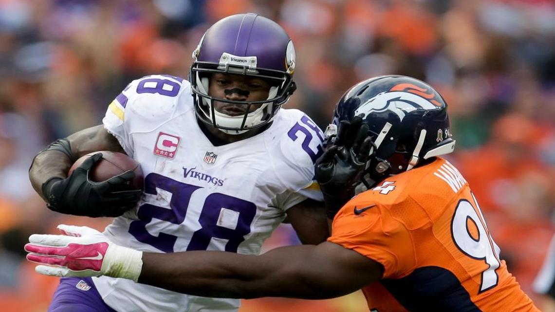 
Vikings running back Adrian Peterson (left) pushes Broncos outside linebacker DeMarcus Ware away during the second half of their Oct. 4 game in Denver.
